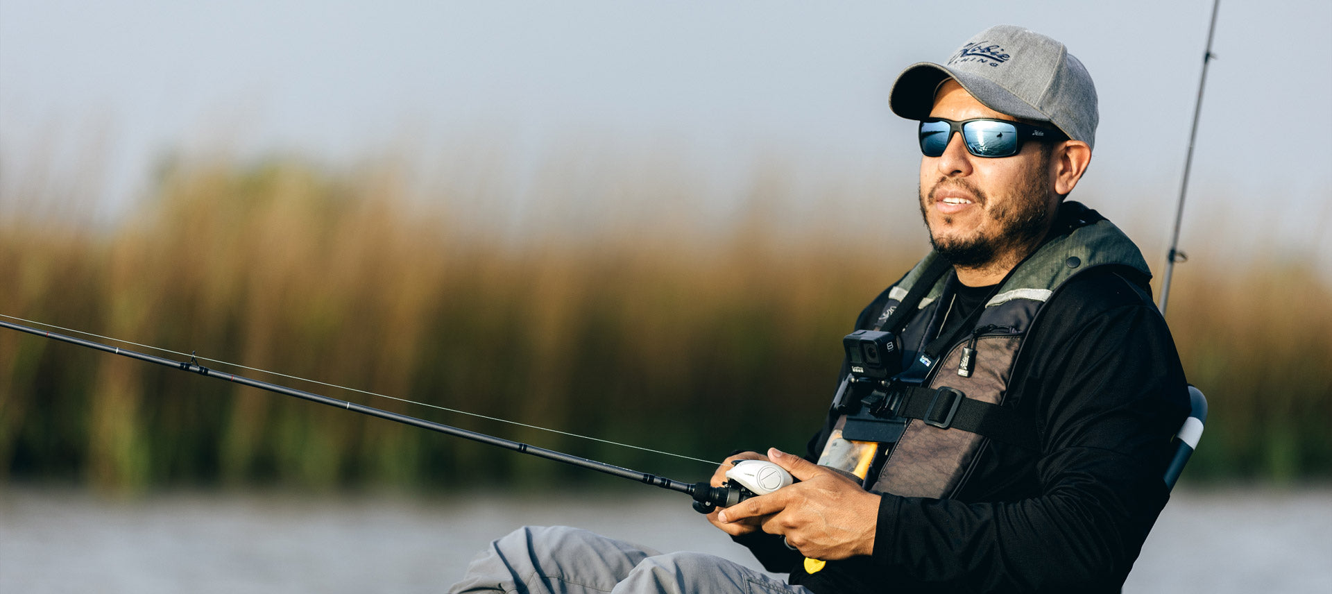 Angler fishing with Hobie Eyewear Mojo Polarized Sunglasses and Hobie hat.
